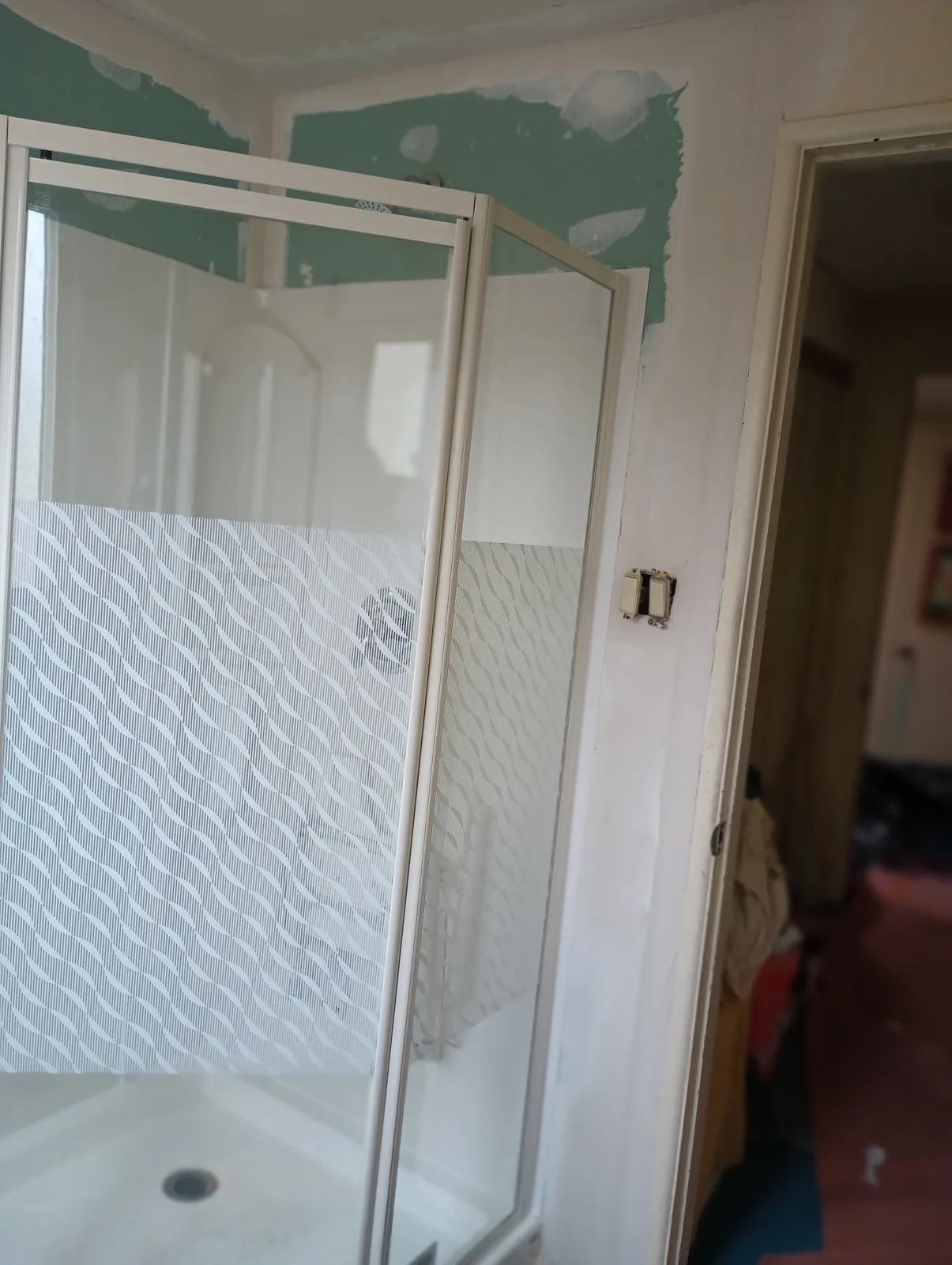 Custom tiled shower installation in progress before glass enclosure work
