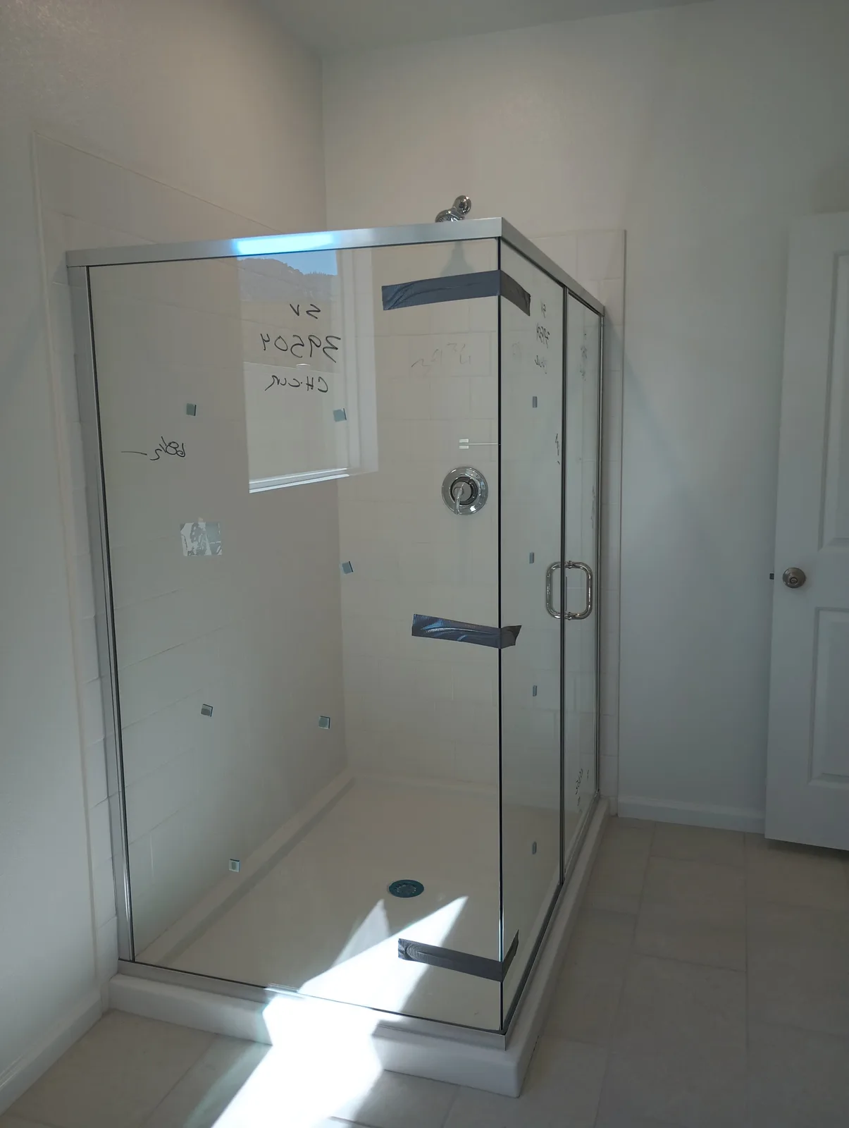 Frameless glass panels secured while protective sealant cures