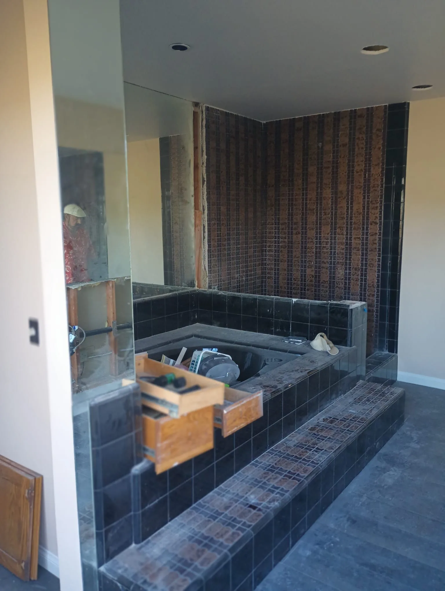 Sunken tub surround and built-in cabinetry during demolition