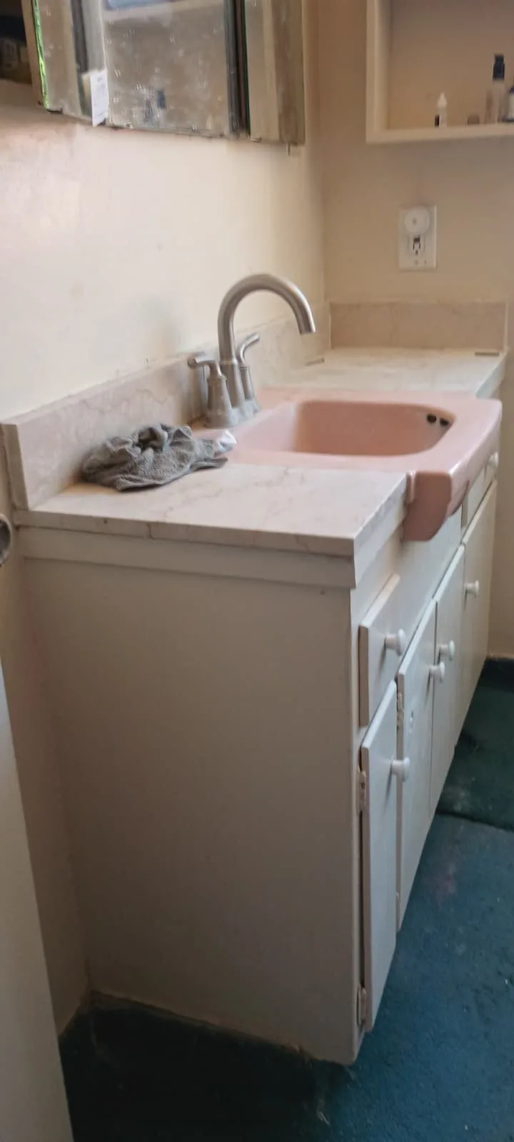 Dated pink drop-in vanity before bathroom modernisation
